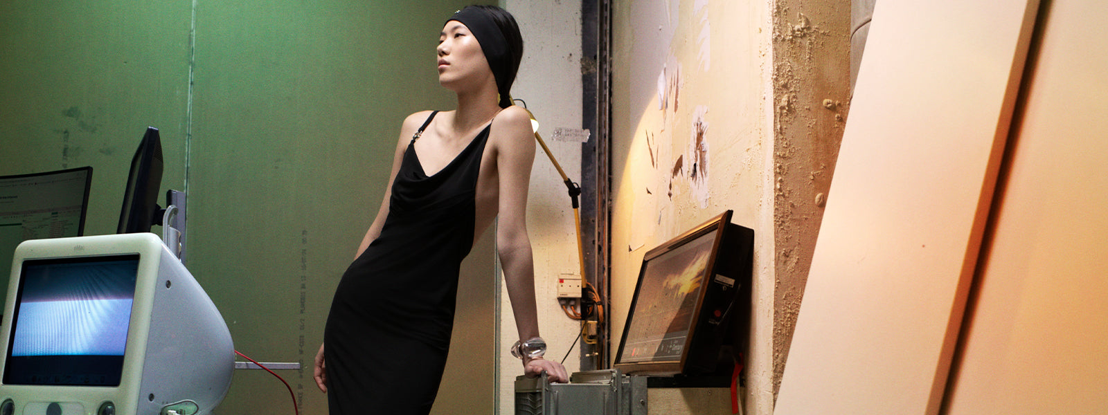 Model wearing Black Coperni Logo Dress, silver bangle, and Black Logo Head Band in an editorial campaign. 